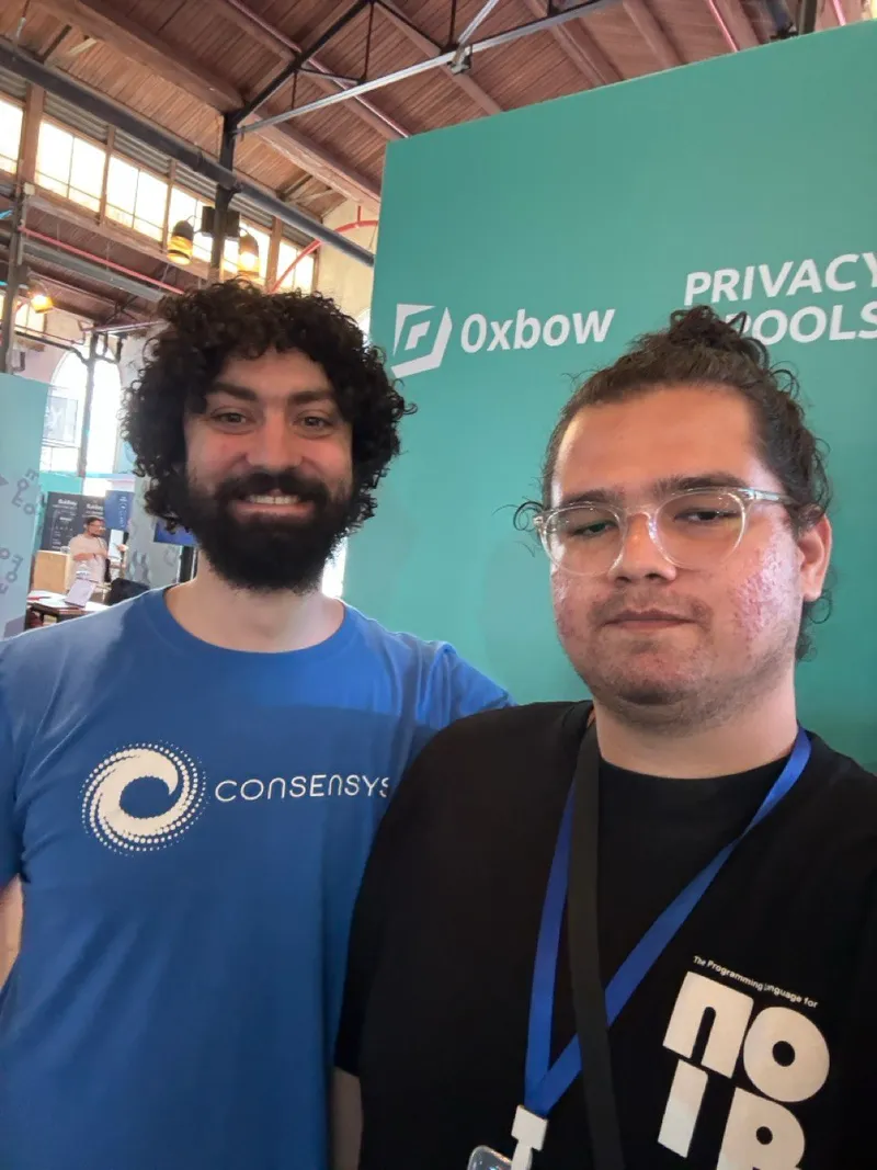 Gerson with Ameen Soleimani at Devconnect 2025, in front of 0xbow Privacy Pools banner